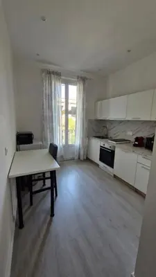 a large kitchen with a table and a table sidx sidx sidx at Chateauneuf in Nice