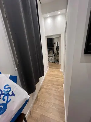 a hallway with black curtains and a wooden floor at Appartement vieux Nice in Nice