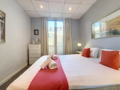 a bedroom with a large bed with towels on it at Nestor&Jeeves - ALPHONSE KARR TERRASSE - Hyper center - Close sea - Chic street in Nice