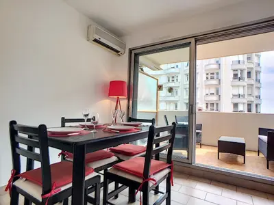a dining room with a table and chairs and a window at Nestor&Jeeves - CARDELINE TERRASSE - Very close sea - Spacious in Nice
