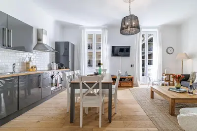 a kitchen and living room with a table and chairs at Wide & Central 3 Bdr - AC & Balcony in Nice