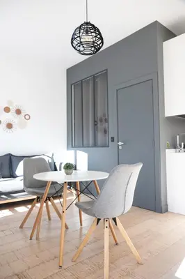 a room with a wooden cabinet with plants on the wall at Cozy apartment Nice center in Nice