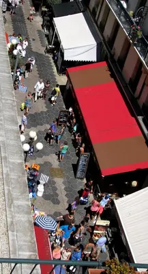 an overhead view of a crowd of people sitting on a street at Appartamento in rue Halevy in Nice