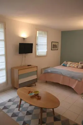a small kitchen with a counter and a table at Le 7 Augustin in Nice