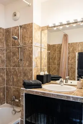a bathroom with a sink and a shower and a mirror at Carpe Diem in Beaulieu-sur-Mer