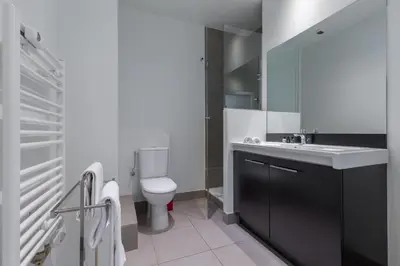 a bathroom with a white sink and a toilet at Nestor&Jeeves - LES AIGLES - Very close sea - Top floor - Luxurious in Nice