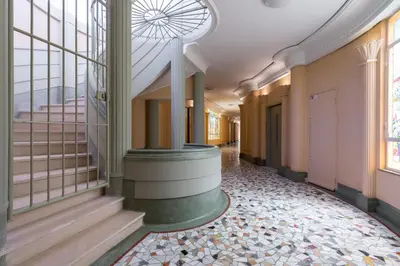 a hallway of a building with a spiral staircase at Nestor&Jeeves - LES AIGLES - Very close sea - Top floor - Luxurious in Nice