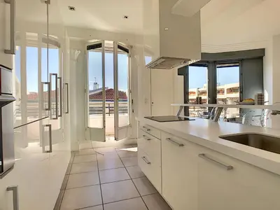 a kitchen with white cabinets and a view of the city at Nestor&Jeeves - LES AIGLES - Very close sea - Top floor - Luxurious in Nice
