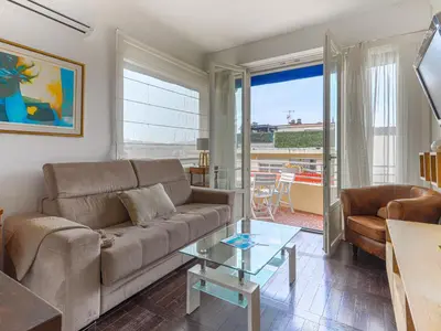 a living room with a couch and a glass table at Apartment Saint Christophe by Interhome in Nice