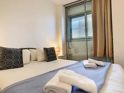 a bedroom with a bed with towels on it at Nestor&Jeeves - SUITE ROYAL LUXEMBOURG - Central - Swimming pool on roof in Nice