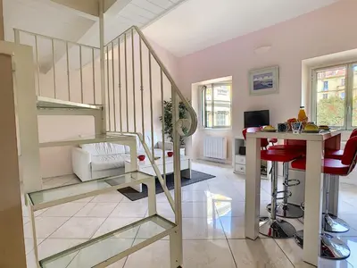 a living room with a spiral staircase and a desk at Nestor&Jeeves - LE DUPLEX - Central - Very close sea in Nice