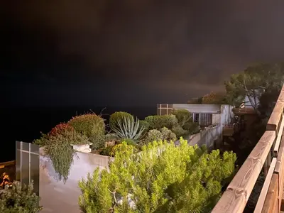 a view of plants on a balcony at night at Unique Apartment - Costa Plana in Cap d'Ail