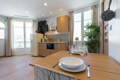 a kitchen with a wooden table with glasses on it at Palais Saint Pierre in Cagnes-sur-Mer