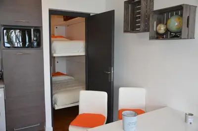 a room with two chairs and a closet with bunk beds at Le Grand Sud in Nice