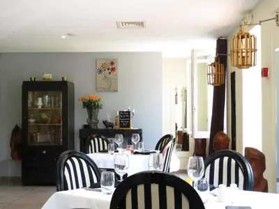 a dining room with a table and chairs with wine glasses at Hotel mon Soleil in La Gaude