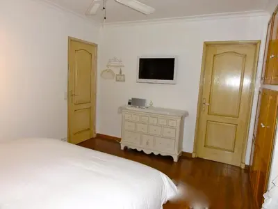 a bedroom with a bed and a tv on the wall at Villa les grimaldines côte d Azur in Cagnes-sur-Mer