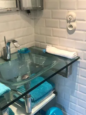 a bathroom sink with a glass counter top at Villa les grimaldines côte d Azur in Cagnes-sur-Mer