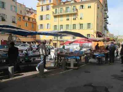 a group of people standing at an outdoor market at Nice Apartment Old Town in Nice