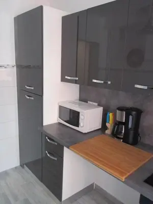 a small kitchen with a microwave on a counter at Nice Apartment Old Town in Nice