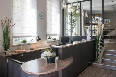 an office with a desk with flowers on it at Hotel Saint Gothard in Nice