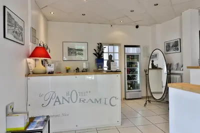 a shop with a counter with a sign on the wall at Le Panoramic Boutique Hôtel in Nice