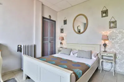 a bedroom with a bed and a mirror on the wall at Le Panoramic Boutique Hôtel in Nice