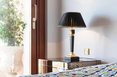 a lamp sitting on a table next to a bed at Sunny Panoramic Balcony in Èze