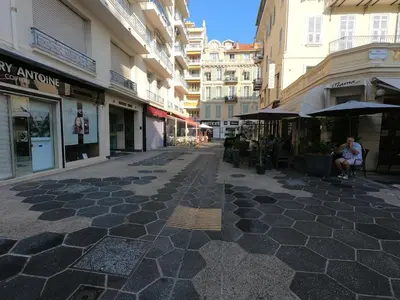 an empty street in a city with buildings at Le Paradis Blue in Nice