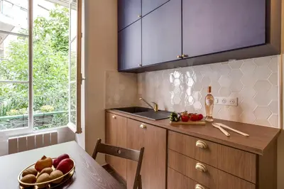 a kitchen with a table with a bowl of fruit on it at CASA NISSARTE - Central near Train station - PARKING - confort & cosy- AC in Nice