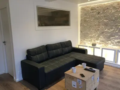 a living room with a black couch and a box at Nicolago in Nice