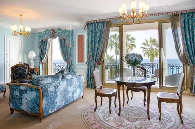 a living room with a couch and a table at Hotel Le Negresco in Nice