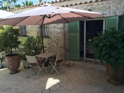 a table and chairs under an umbrella on a patio at La Bergerie B&B in Vence