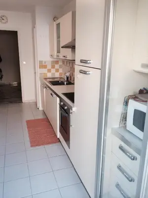 a kitchen with a refrigerator and a sink and a microwave at Appartamento Sole in Nice