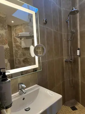 a bathroom with a sink and a shower with a mirror at Boutique Hotel & Spa la Villa Cap Ferrat in Saint-Jean-Cap-Ferrat
