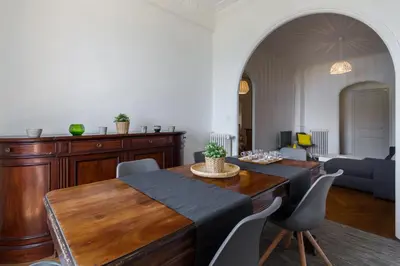 a living room with a wooden table and chairs at Beautiful apartment by the sea front in Nice