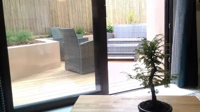 a potted plant sitting on a table next to a sliding glass door at Villa du Chateau in Nice