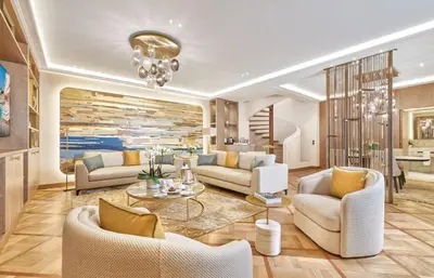 a living room with couches and a table at La Réserve de Beaulieu in Beaulieu-sur-Mer