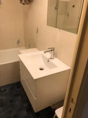 a bathroom with a sink and a mirror and a tub at Nice-Miramar Apartment and Parking in Nice