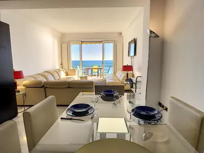 a living room with a table and a couch at Nestor&Jeeves - PALAIS DE FRANCE - Central - Sea front in Nice