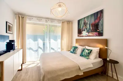 a bedroom with a large bed and a window at CENTRE PROMENADE Golden Square Terrace 1 min Walk to the Beach AC in Nice