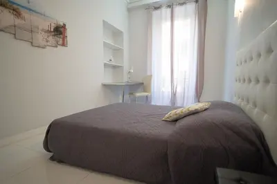a bedroom with a bed and a window at Designer Flat Nice in Nice