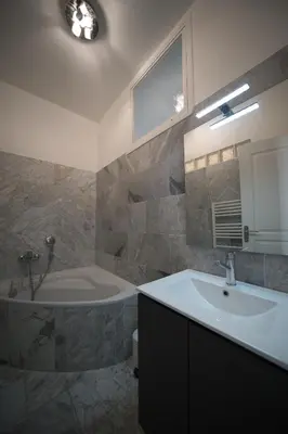 a bathroom with a tub and a sink and a bath tub at Designer Flat Nice in Nice