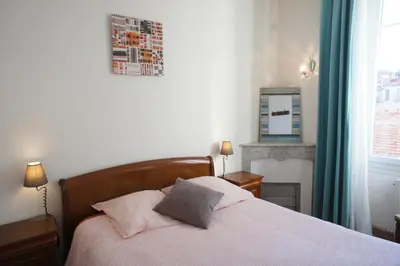 a bedroom with a bed and a fireplace and a window at ZePerfectPlace - Vieux Nice Garibaldi 3 chambres in Nice