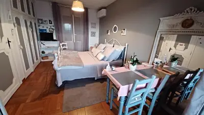 a bedroom with a bed and a table and chairs at La Tuiliere in Saint-Laurent-du-Var