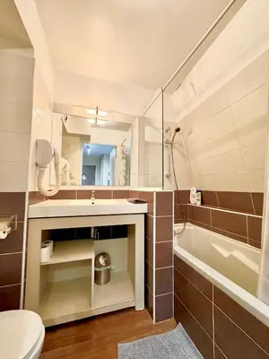 a bathroom with a sink and a tub and a toilet at Nice Centre, Magnifique Studio Proche Mer in Nice