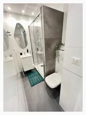 a bathroom with a toilet and a sink and a mirror at Maison de Côte - Felice in Nice