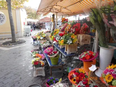 an outdoor flower market with flowers on display at Breakfast at Sophy's in Nice