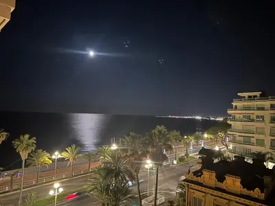 a view of the ocean at night with a moon at Sea View - Promenade des Anglais 1 Bdr in Nice