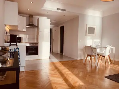 a kitchen and dining room with a table and chairs at Appartement 2 chambres avec Terrasse Vue sur la Mer in Nice