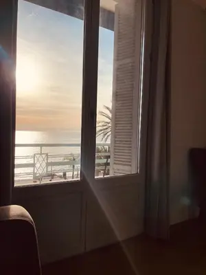 a room with a window looking out at the ocean at Appartement 2 chambres avec Terrasse Vue sur la Mer in Nice